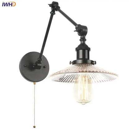Industrial black swing arm wall light fixture with faceted glass shade