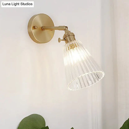 Industrial brass and clear textured glass wall sconce dining room