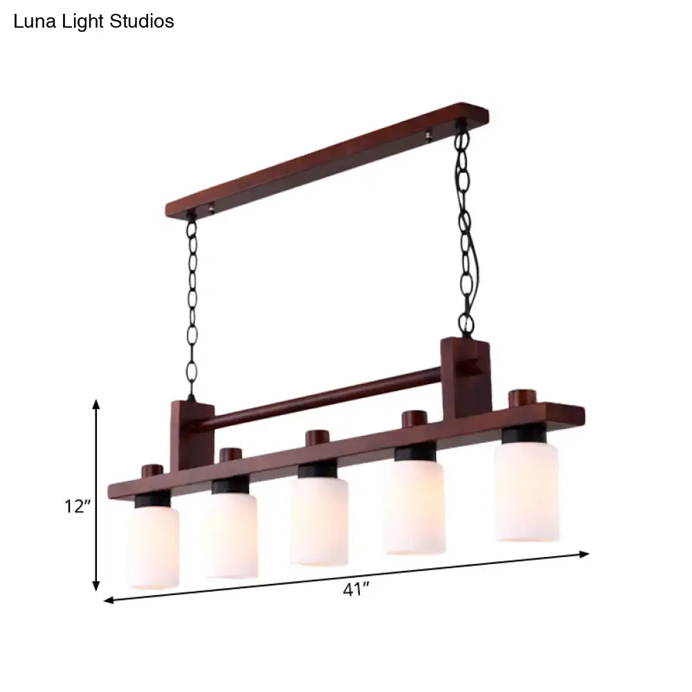 Traditional linear wood island pendant with opal glass dining room