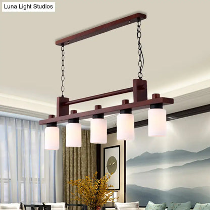 Traditional linear wood island pendant with opal glass dining room