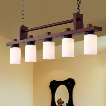 Traditional linear wood island pendant with opal glass dining room