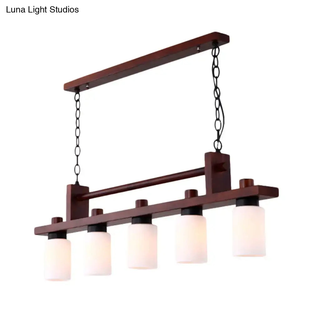 Traditional linear wood island pendant with opal glass dining room