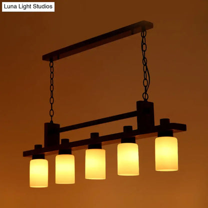 Traditional linear wood island pendant with opal glass dining room