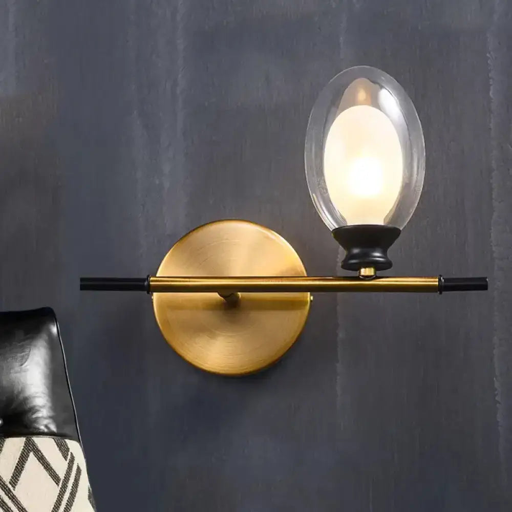 Mid century gold and black wall lamp with amber glass shade bedroom
