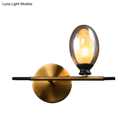 Mid century gold and black wall lamp with amber glass shade bedroom