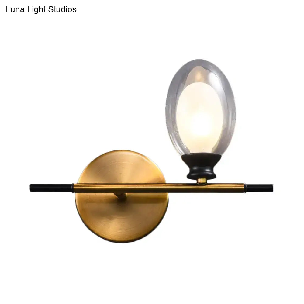 Mid century gold and black wall lamp with amber glass shade bedroom