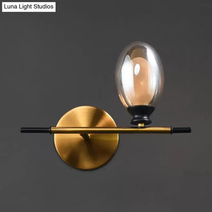 Mid century gold and black wall lamp with amber glass shade bedroom