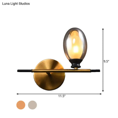Mid century gold and black wall lamp with amber glass shade bedroom