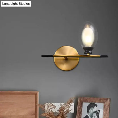 Mid century gold and black wall lamp with amber glass shade bedroom