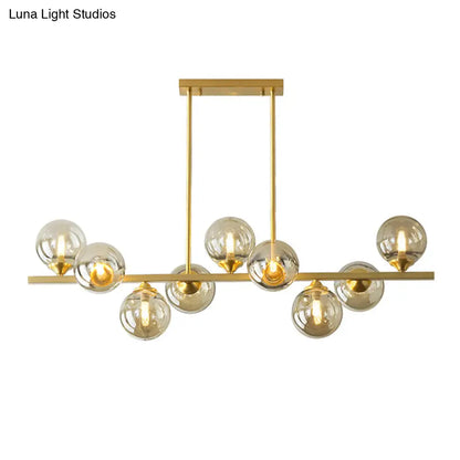 DecorBites™ Mid-Century Modern Gold Metal Pendant with Spherical Amber Glass - Island Ceiling Light for Dining Table