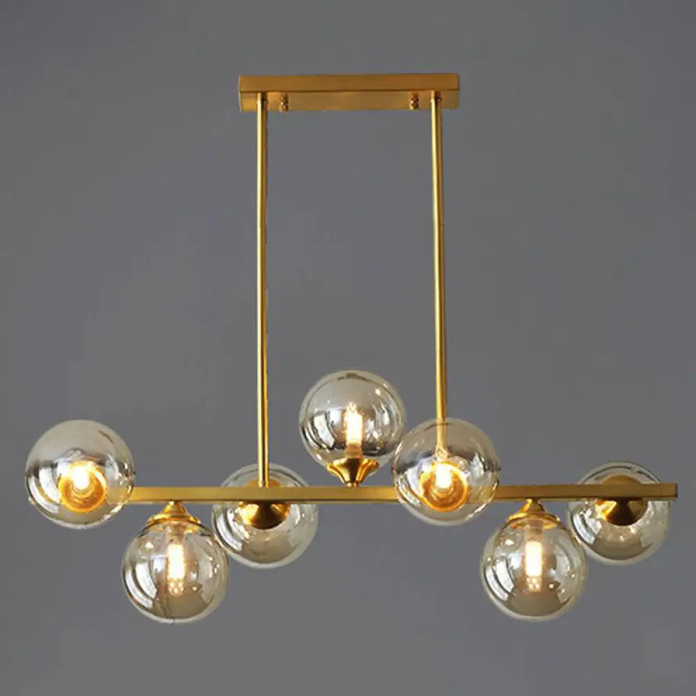 DecorBites™ Mid-Century Modern Gold Metal Pendant with Spherical Amber Glass - Island Ceiling Light for Dining Table
