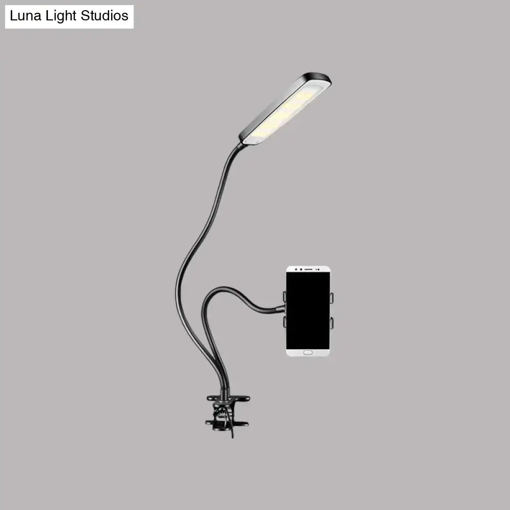 Minimalist black flexible arm desk lamp with phone holder bedroom
