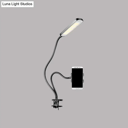 Minimalist black flexible arm desk lamp with phone holder bedroom