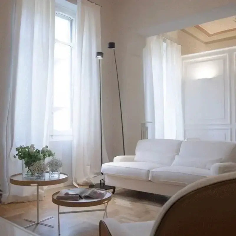 Minimalist black floor lamp with curved led arms for living room