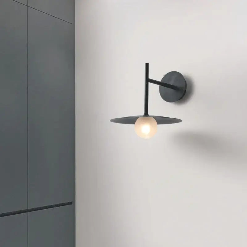 Minimalist black flying saucer wall lamp for bedroom decor