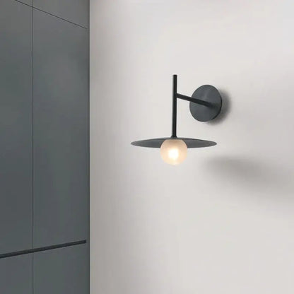 Minimalist black flying saucer wall lamp for bedroom decor
