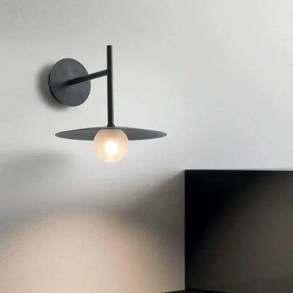 Minimalist black flying saucer wall lamp for bedroom decor
