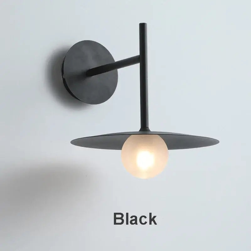 Minimalist black flying saucer wall lamp for bedroom decor