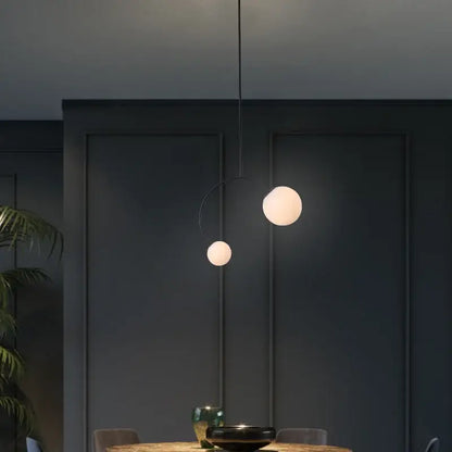 Minimalist black glass ball pendant lights – dining room curved arm