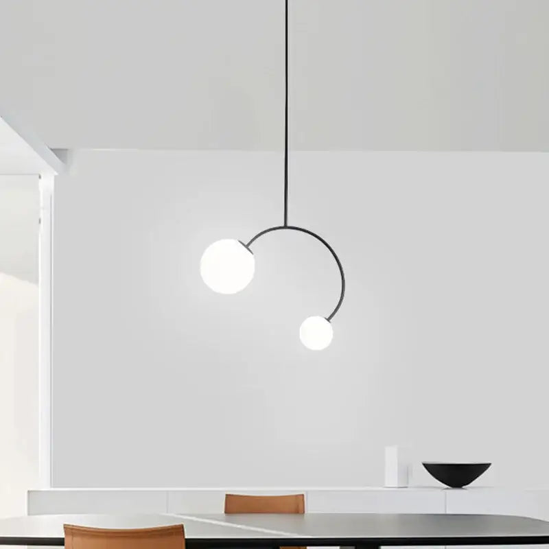 Minimalist black glass ball pendant lights – dining room curved arm