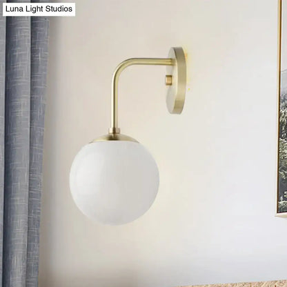 Minimalist black & gold wall light with milky glass ball for bedroom