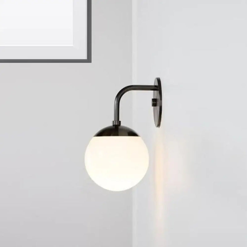 Minimalist black & gold wall light with milky glass ball for bedroom