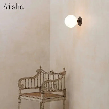 Minimalist black wall lamp with white glass globe bedroom lighting fixture