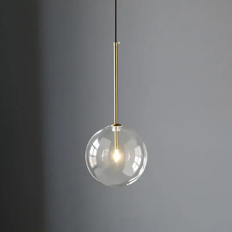 Minimalist brass and clear glass ball pendant light for dining room