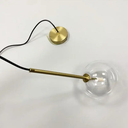Minimalist brass and clear glass ball pendant light for dining room