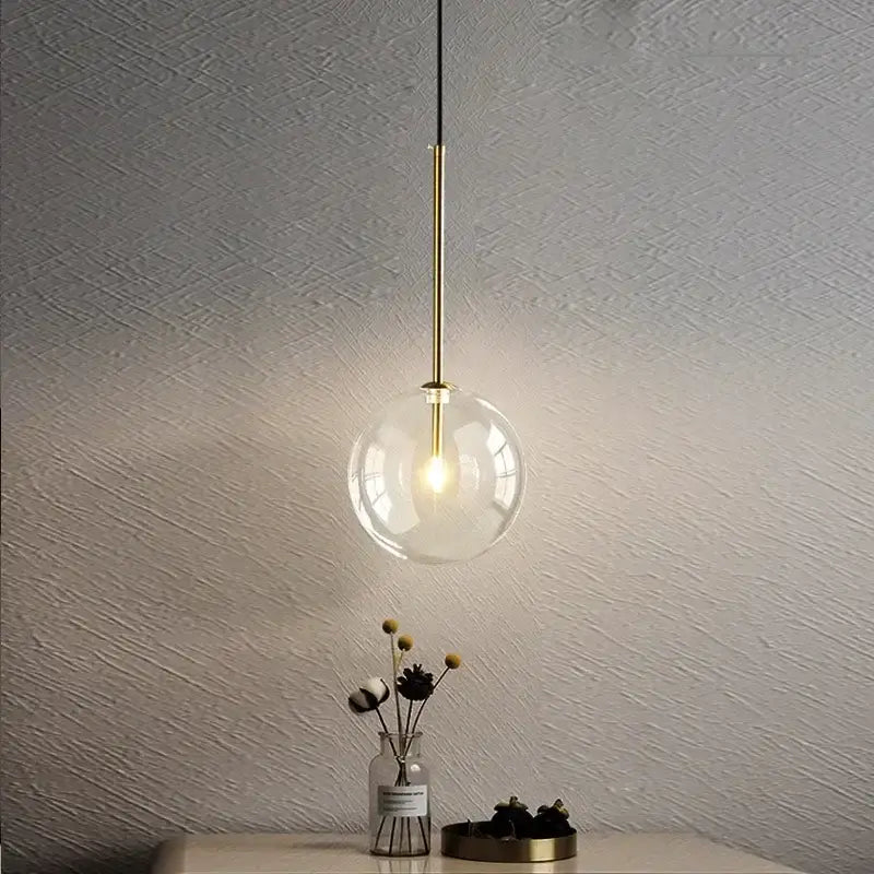 Minimalist brass and clear glass ball pendant light for dining room
