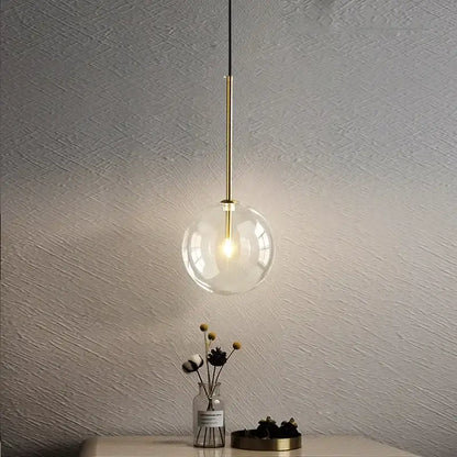Minimalist brass and clear glass ball pendant light for dining room