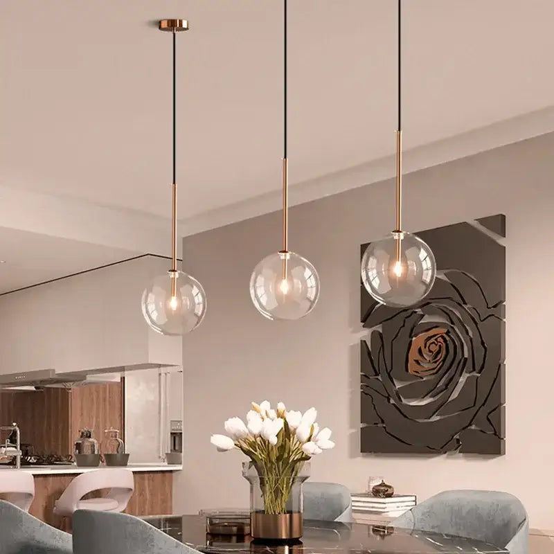 Minimalist brass and clear glass ball pendant light for dining room