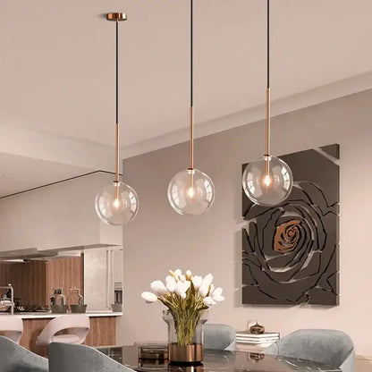 Minimalist brass and clear glass ball pendant light for dining room
