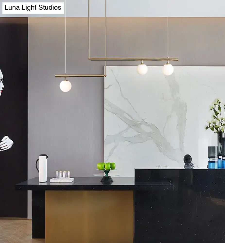Minimalist brass and white glass ceiling light for kitchen island