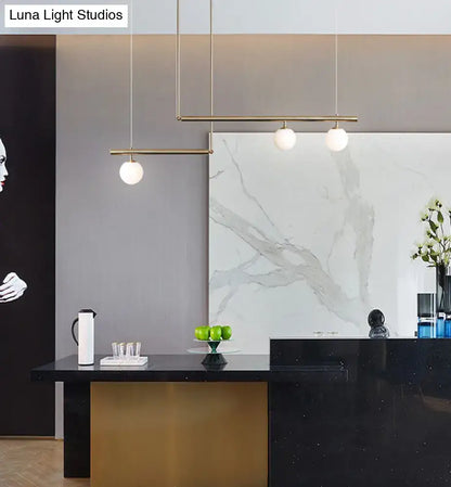 Minimalist brass and white glass ceiling light for kitchen island