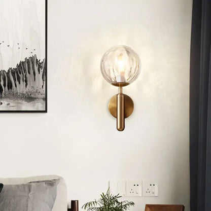 Minimalist brass textured glass globe wall mount light for bedroom