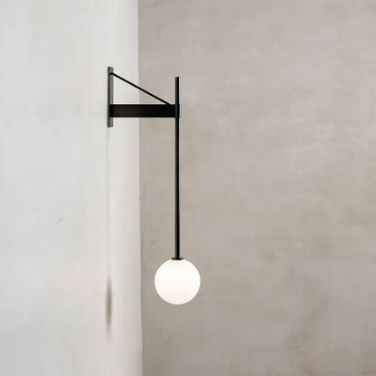 Minimalist geometric iron wall lamp with glass globe for bedroom