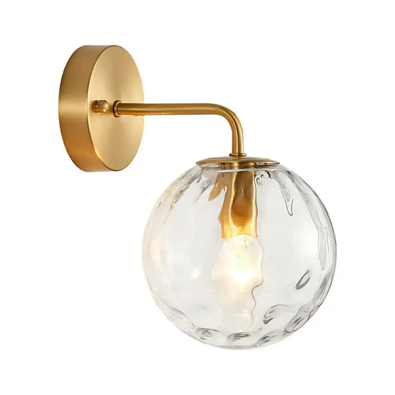 Minimalist gold ball sconce with hammered glass shade bedroom light