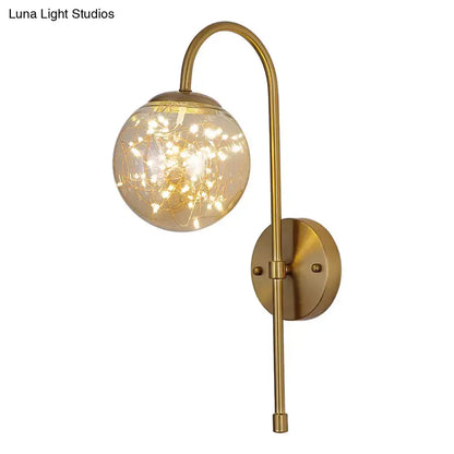 Minimalist gold gooseneck wall light with fairy light globe bedroom