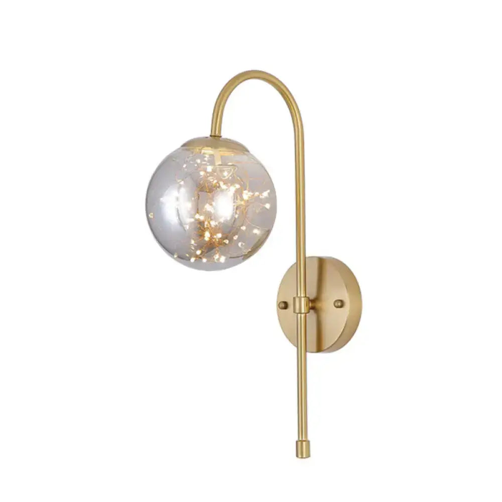 Minimalist gold gooseneck wall light with fairy light globe bedroom