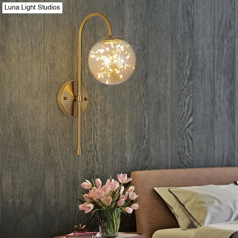 Minimalist gold gooseneck wall light with fairy light globe bedroom