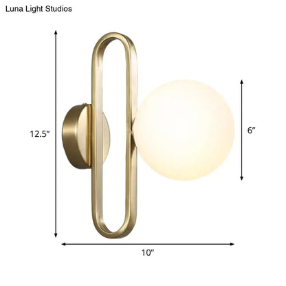 Minimalist gold oval arm wall light with cream matte glass bedroom sconce