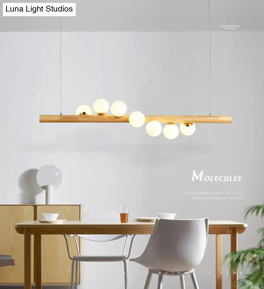 Minimalist wood and glass linear island pendant for kitchen lighting