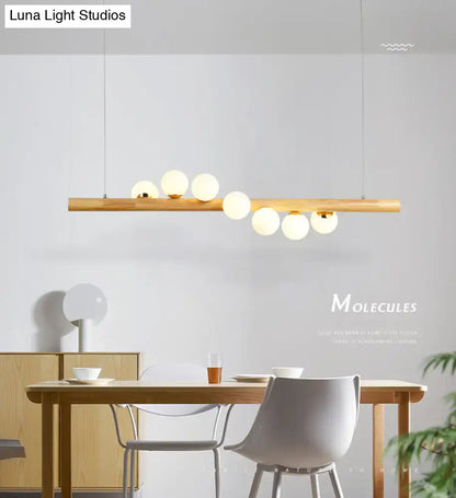 Minimalist wood and glass linear island pendant for kitchen lighting