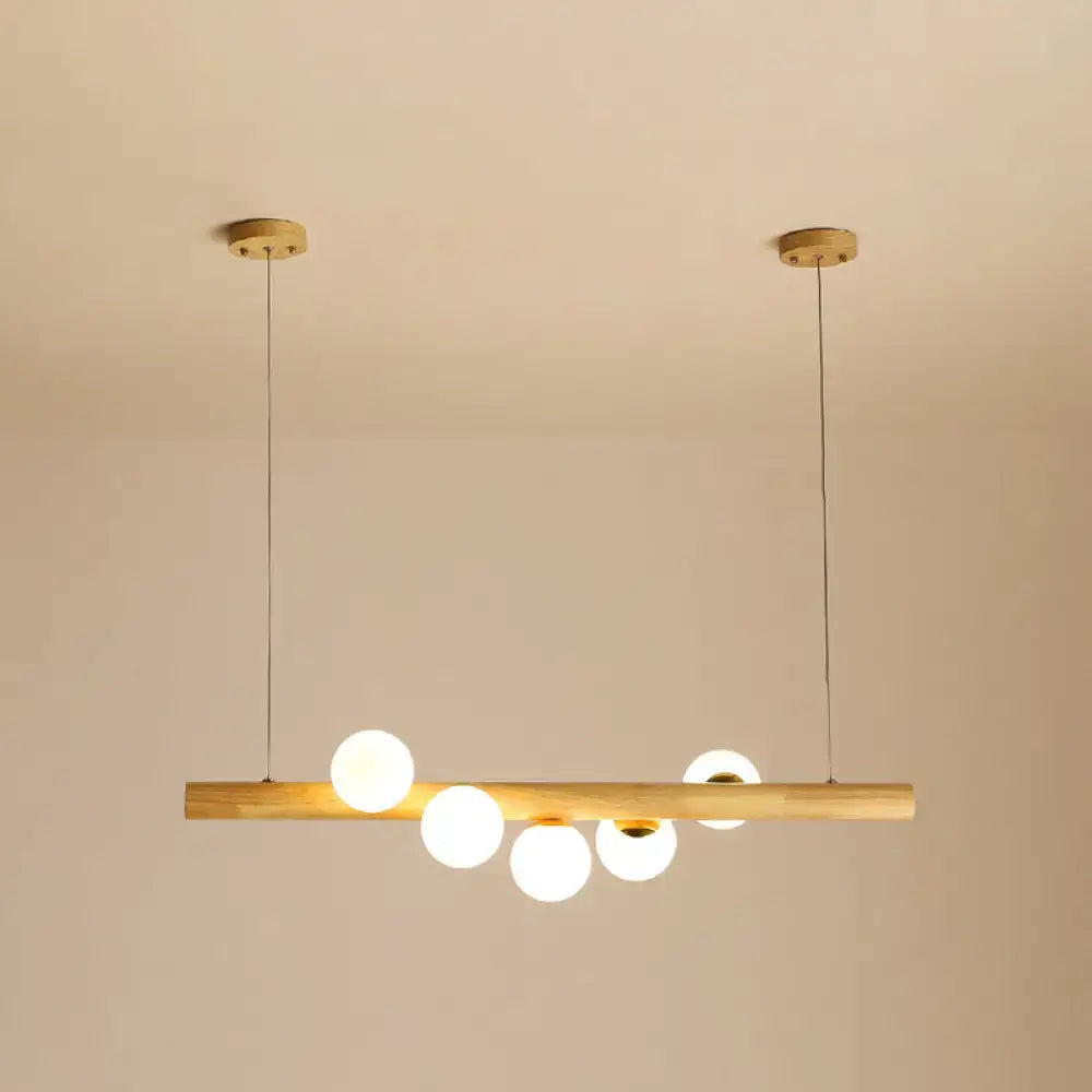 Minimalist wood and glass linear island pendant for kitchen lighting