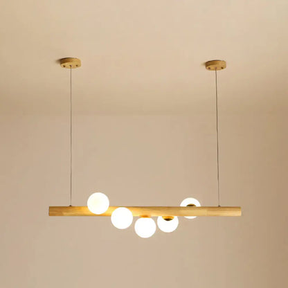 Minimalist wood and glass linear island pendant for kitchen lighting