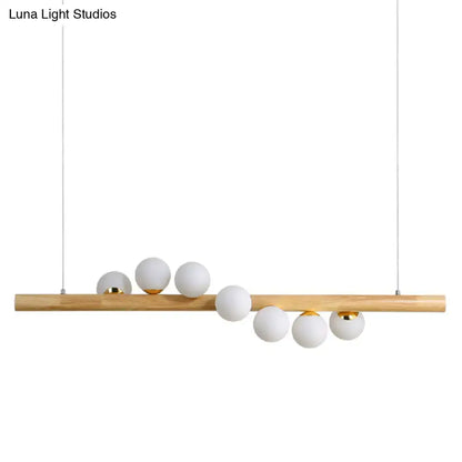 Minimalist wood and glass linear island pendant for kitchen lighting