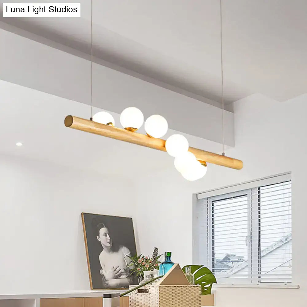 Minimalist wood and glass linear island pendant for kitchen lighting