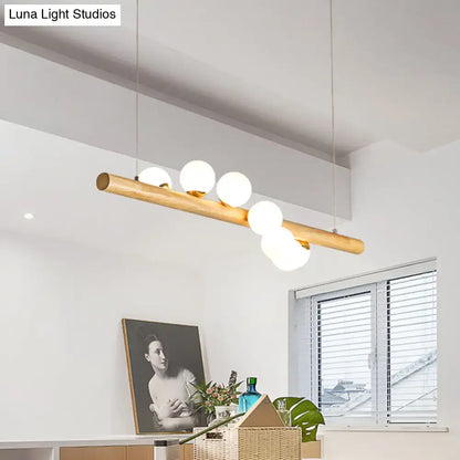 Minimalist wood and glass linear island pendant for kitchen lighting