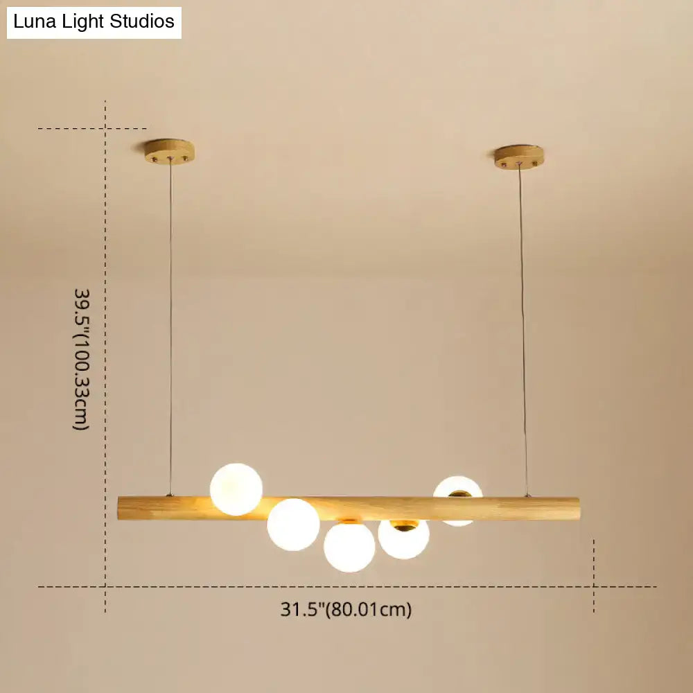 Minimalist wood and glass linear island pendant for kitchen lighting